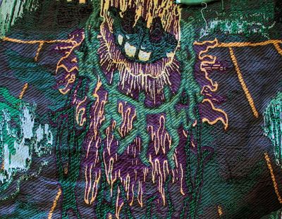 Image: Olivia Rode Hvass, De Varme hænder (Hot hands!), 2023, tapestry (cotton, burnt wood, natural stone, posca marker, spray paint, plants, sand). Courtesy the Artist.